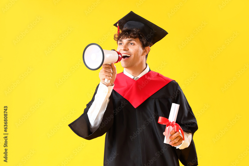 Male graduate student with diploma shouting into megaphone on yellow background