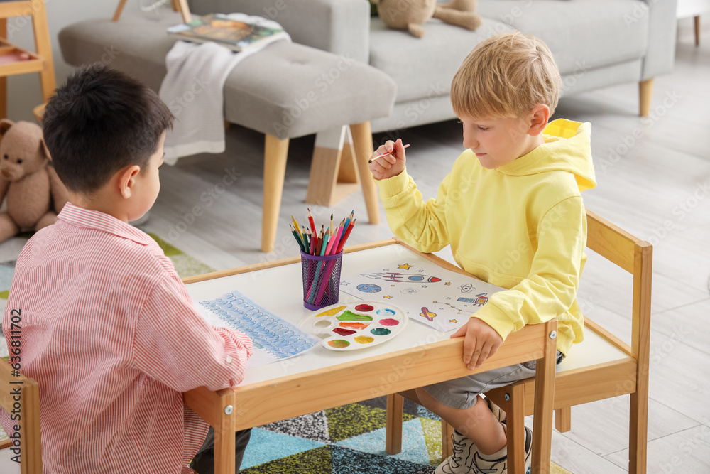 Cute little boys drawing at home