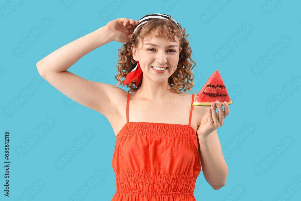 Happy beautiful young woman with slice of fresh watermelon on blue background