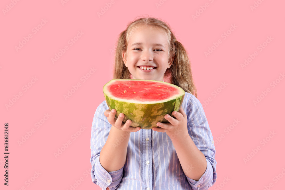 Happy little girl with half of fresh watermelon on pink background