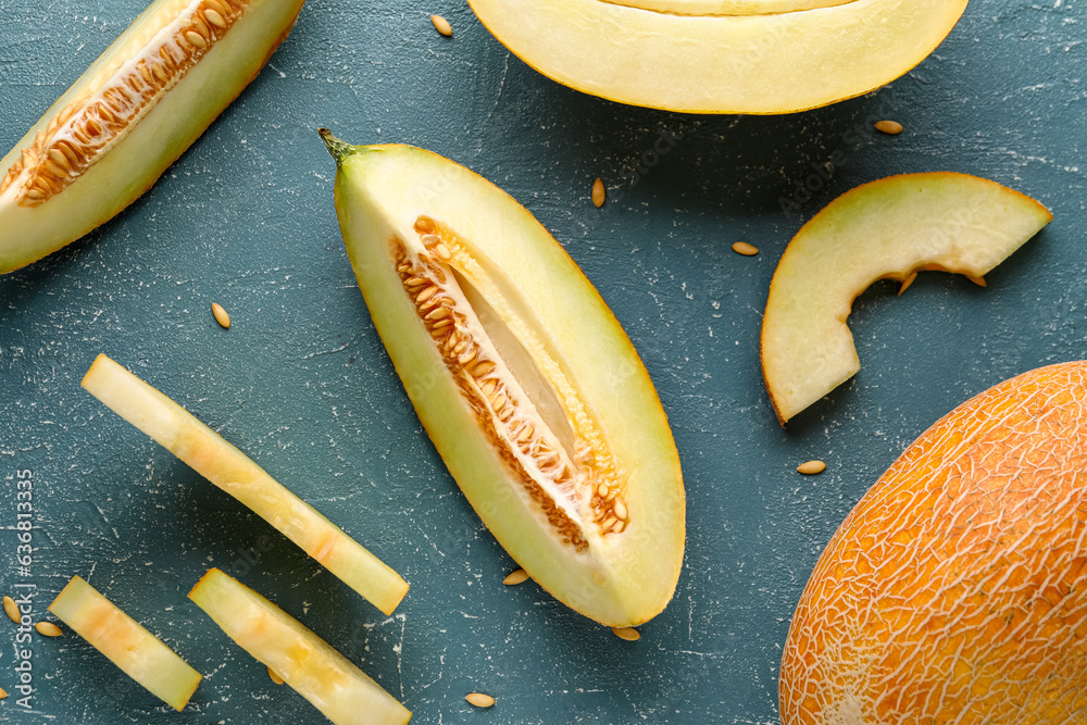 Pieces of sweet melon and seeds on blue background