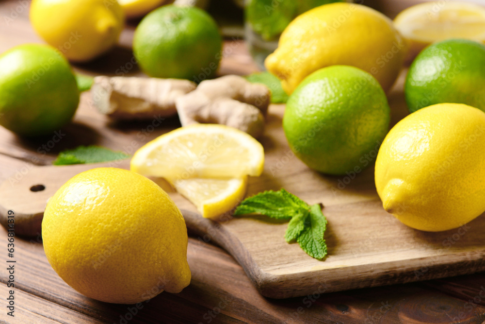 Board with citrus fruits for preparing fresh lemonade on wooden background