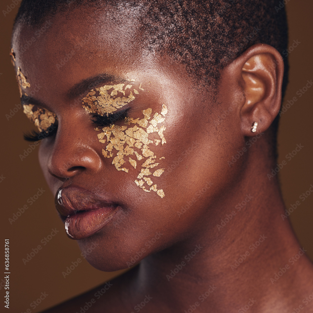 Gold, art and face of black woman with makeup for beauty aesthetics isolated in a studio brown backg