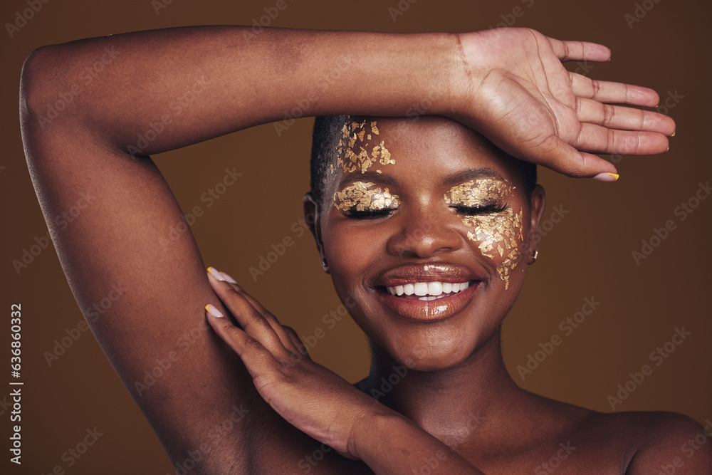 Gold, creative and art on black woman with makeup for beauty aesthetics isolated in studio brown bac