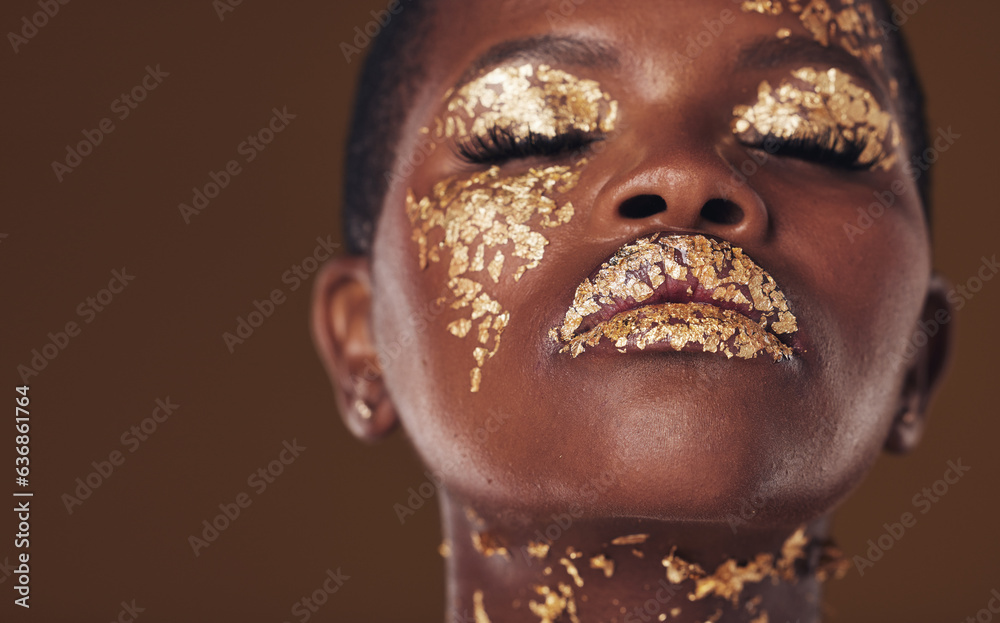 Gold, art and face of African woman with makeup for beauty aesthetics isolated in a studio brown bac