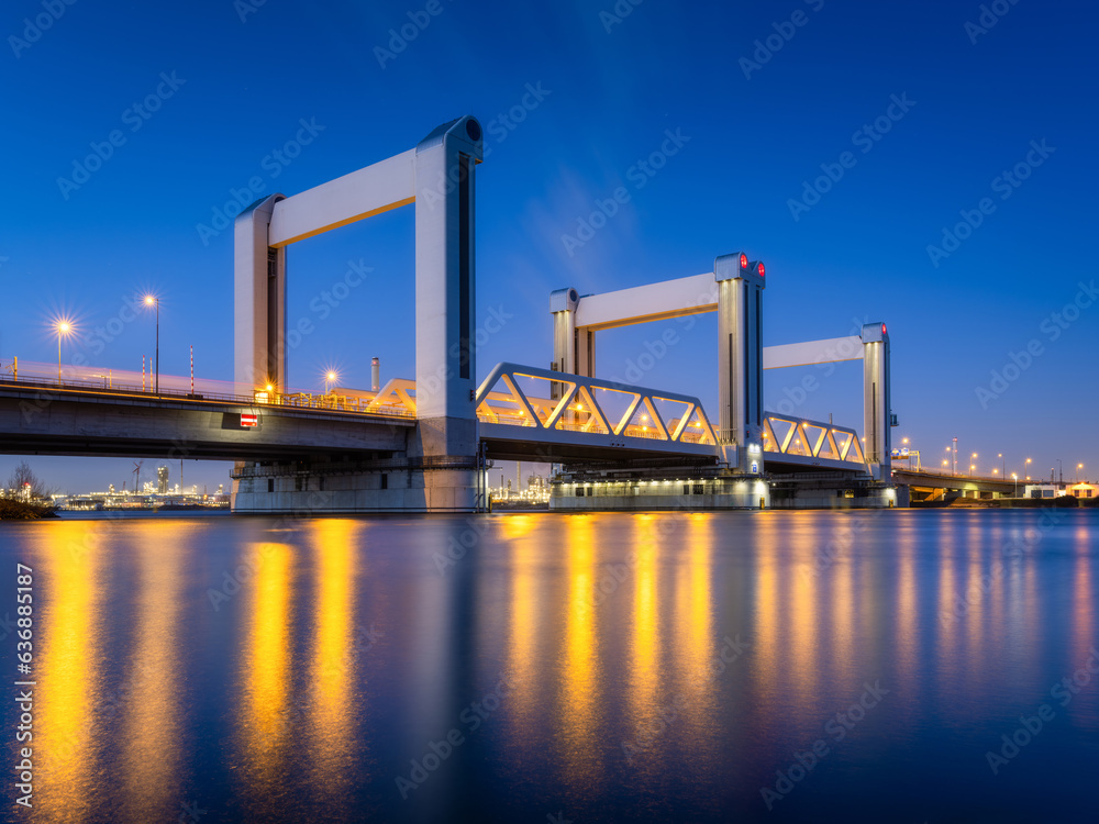 Botlek bridge, Rotterdam, Netherlands. View of the bridge at night.  Road for cars and railroad tran