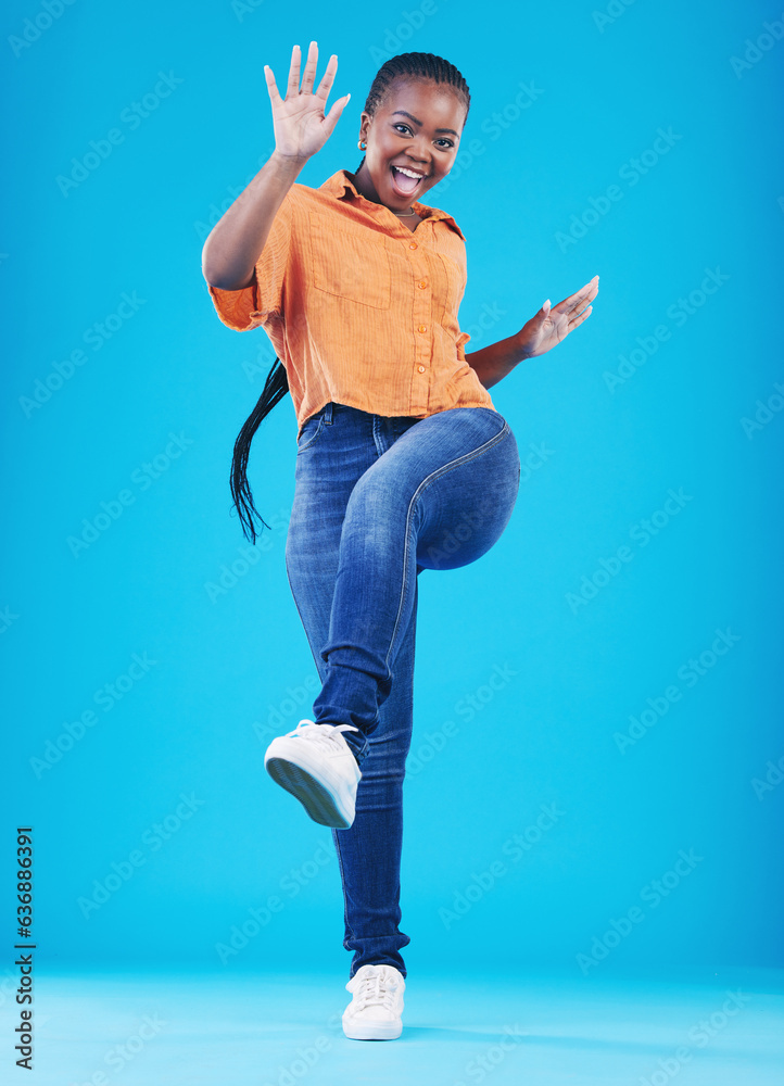 Woman, excited and leg up to celebrate in studio for achievement, promotion or sale deal. Portrait o