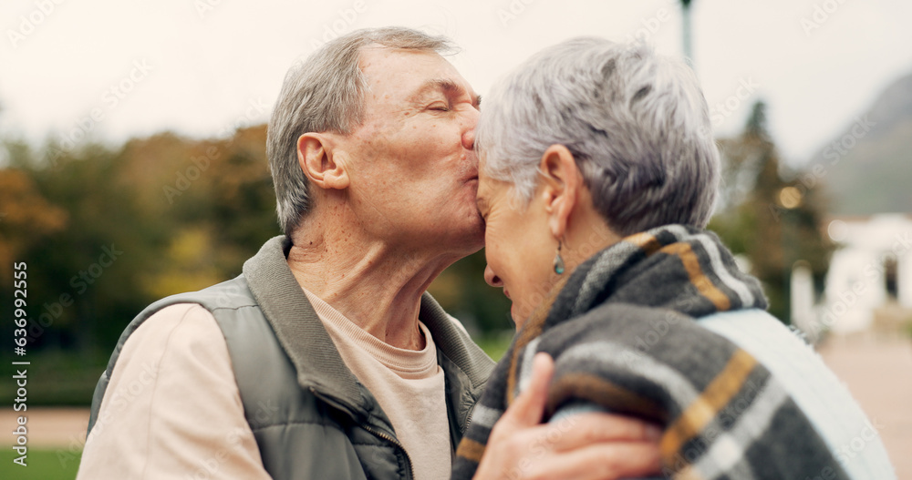 Kiss, forehead and senior couple in a park with love, happy and conversation with romantic bonding. 