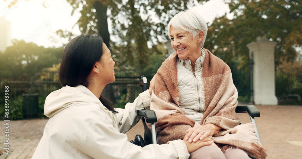 Wheelchair, park and a senior woman with a disability talking to her nurse during a walk together ou