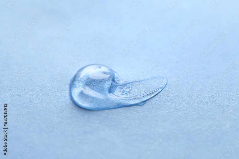 Sample of transparent gel on light blue background, closeup