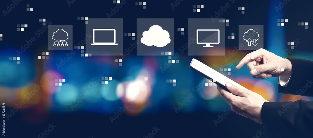 Cloud computing with businessman using a tablet computer at night