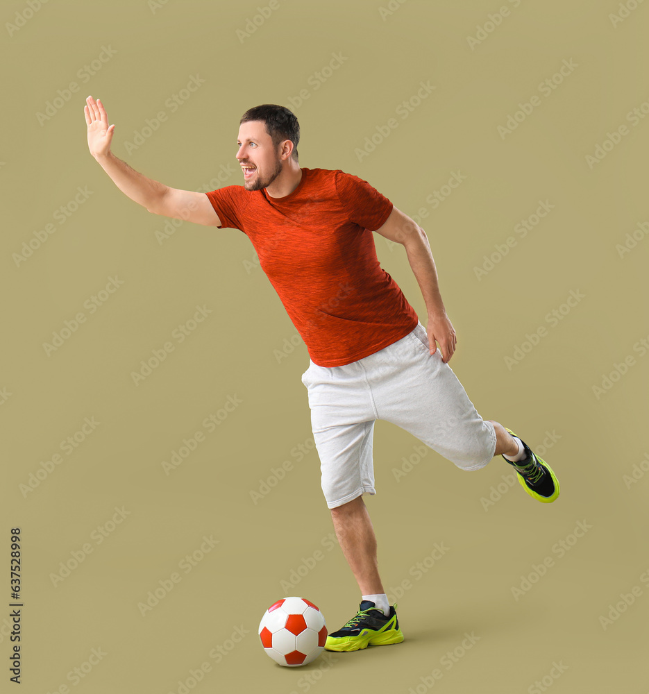 Man playing with soccer ball on color background