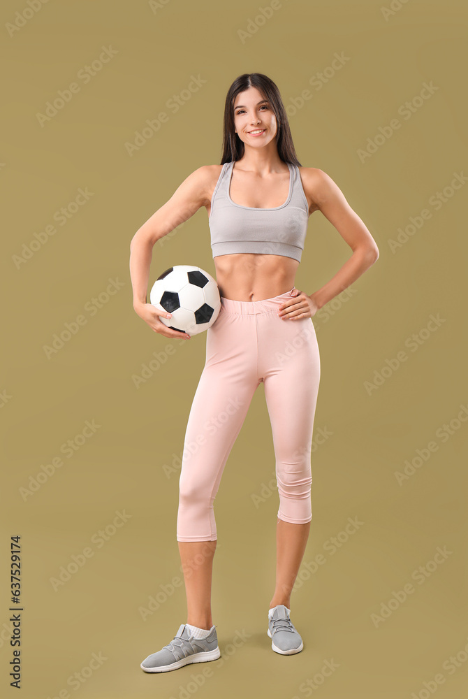 Sporty young woman with soccer ball on color background