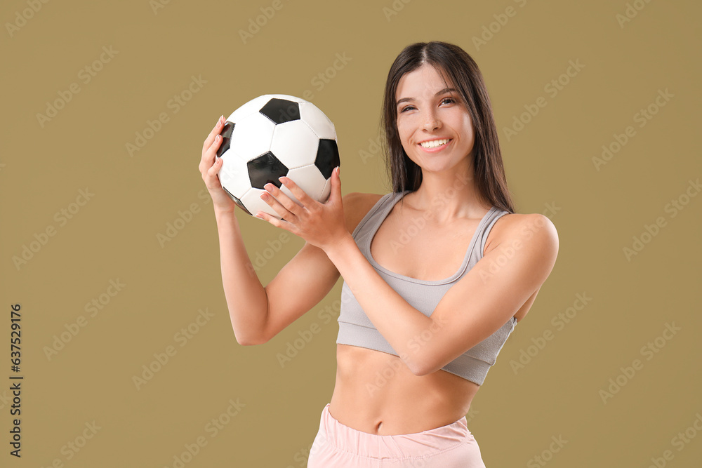 Sporty young woman with soccer ball on color background