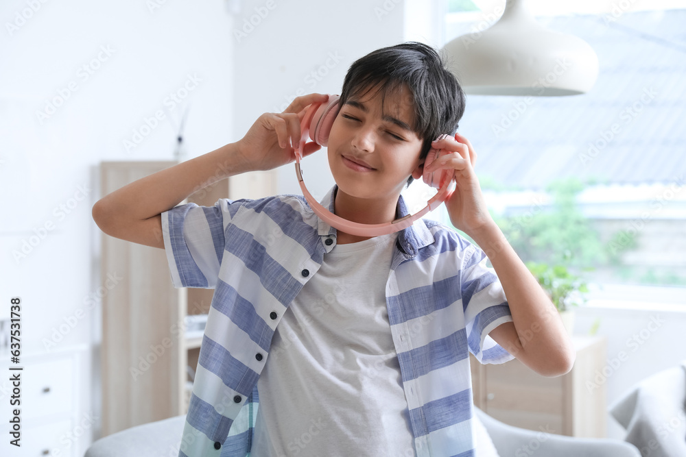 Little boy in headphones dancing at home