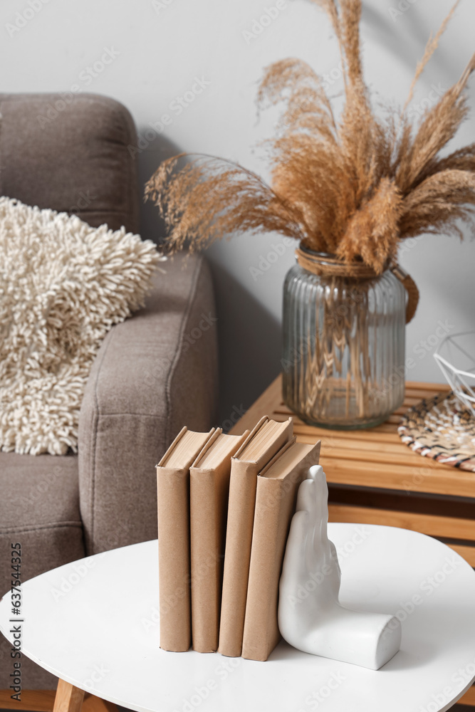 Holder with books on table in living room