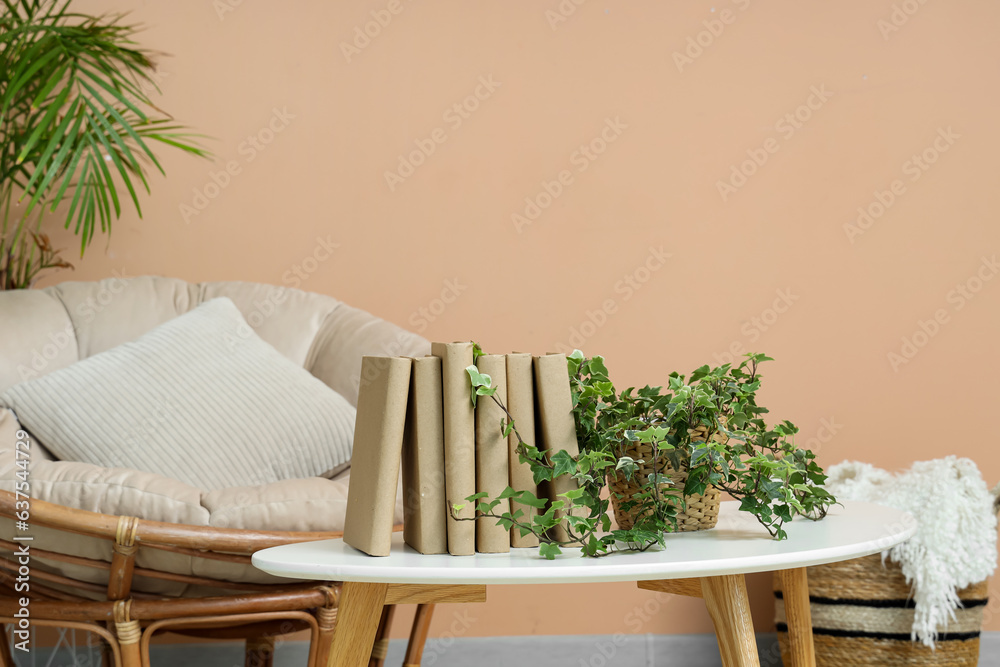 Books with houseplant on table in living room