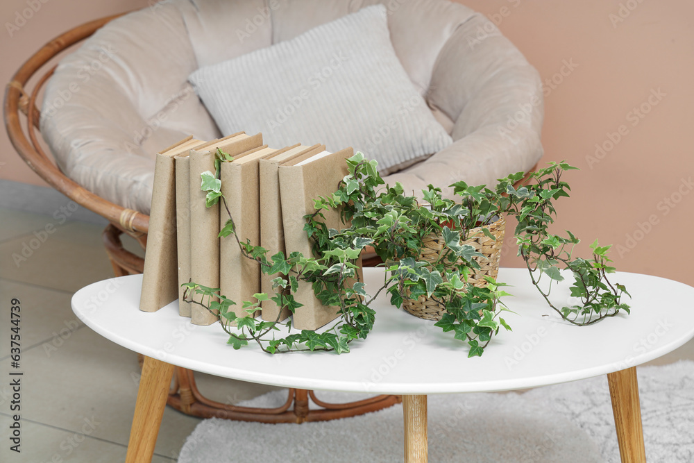 Books with houseplant on table in living room