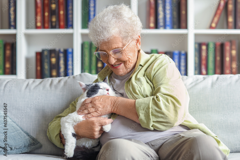 Senior woman with cute cat resting at home