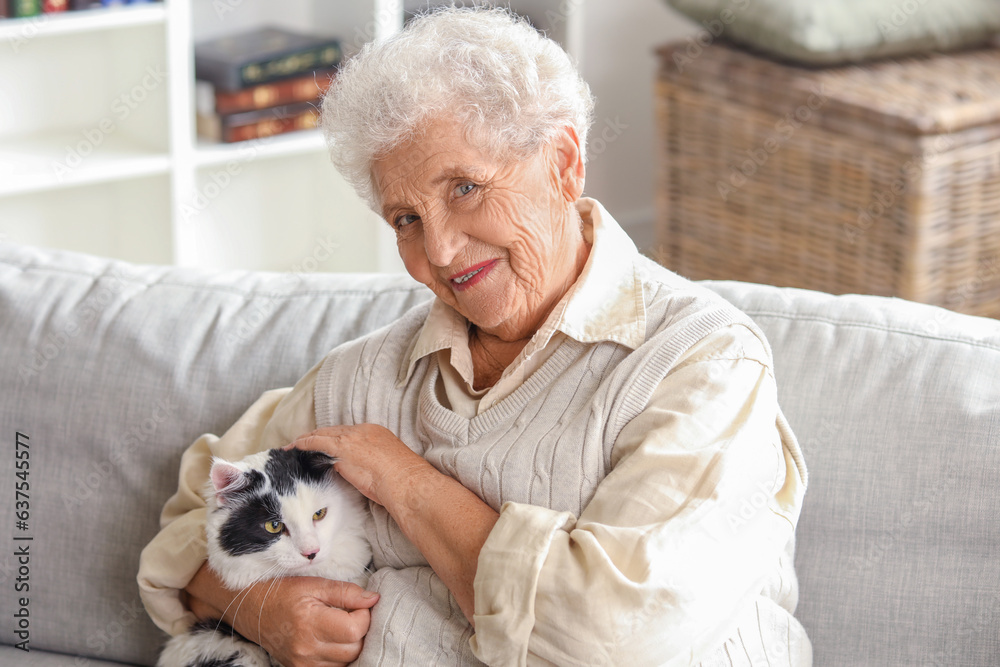 Senior woman with cute cat resting at home