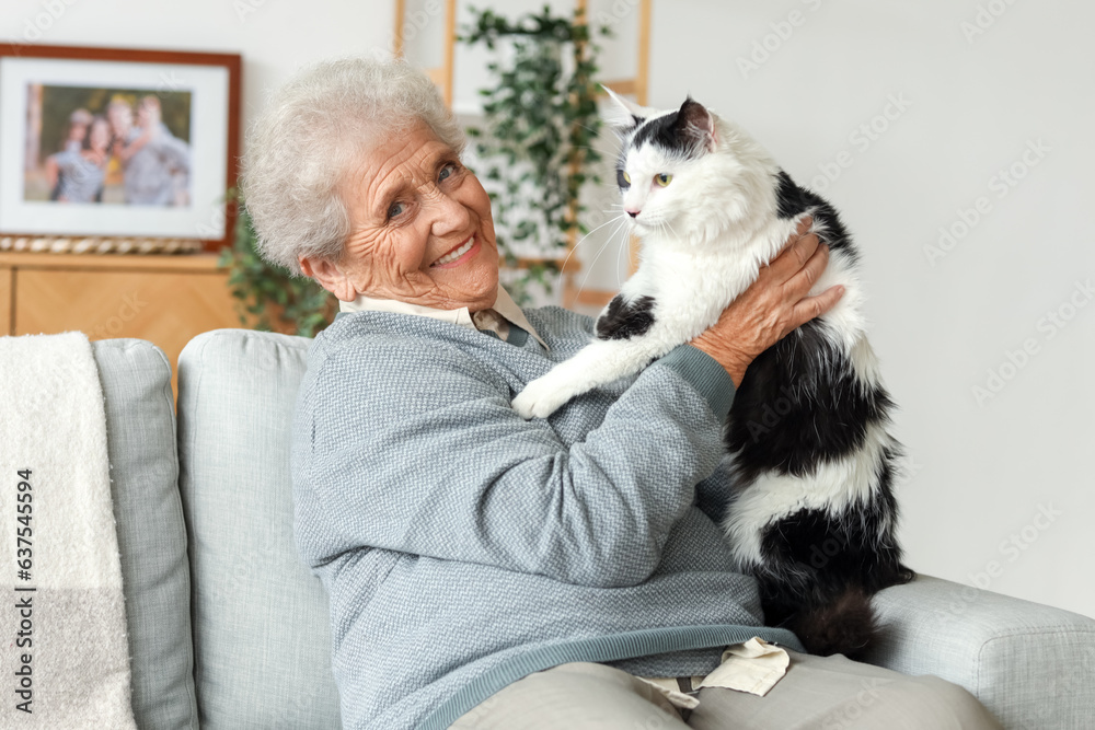 Senior woman with cute cat resting at home