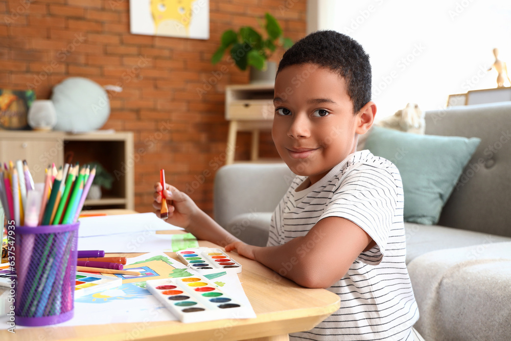 Little African-American boy drawing at home