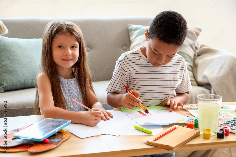 Cute little children drawing at home