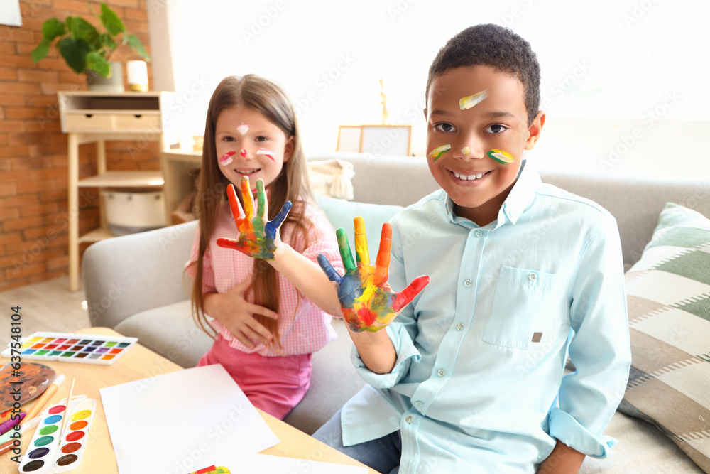 Cute little children in paint at home