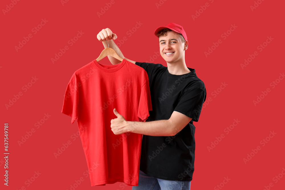 Young man with t-shirt showing thumb-up on red background