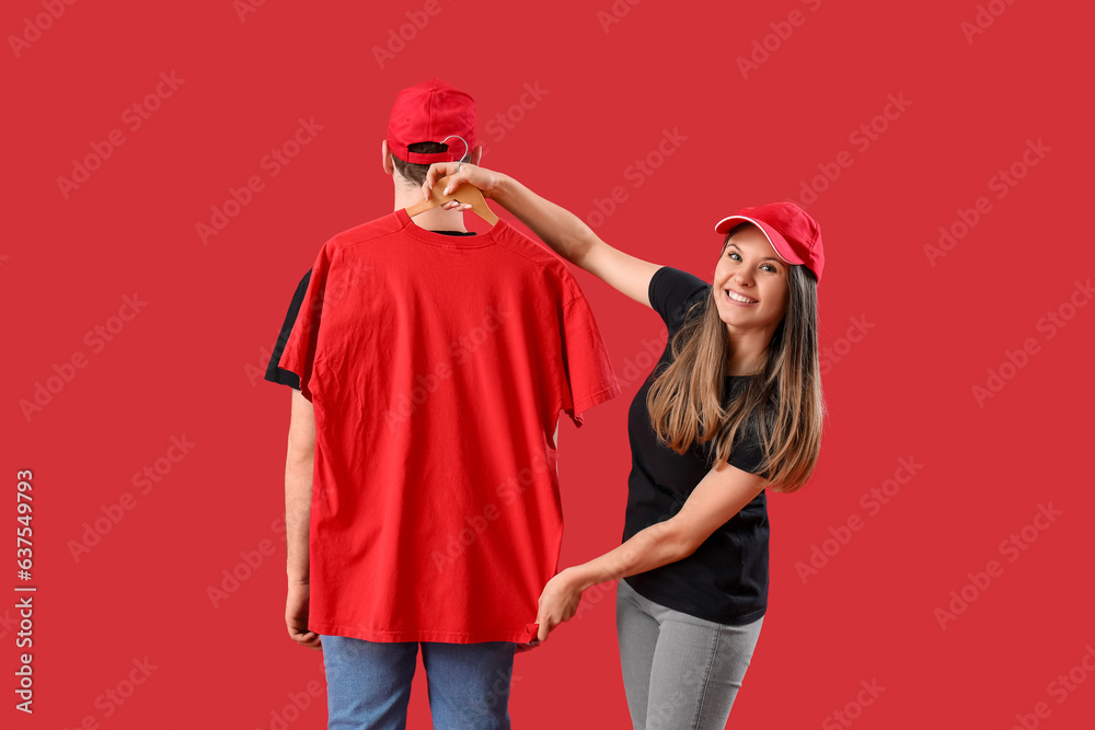 Young couple with t-shirt on red background