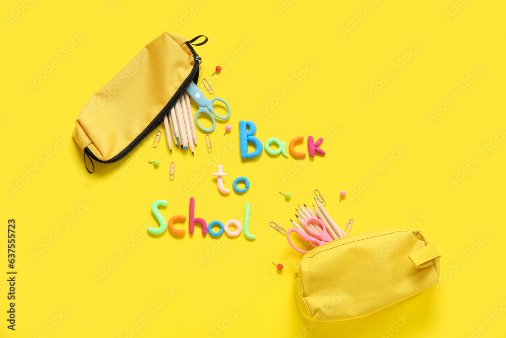 Text BACK TO SCHOOL and stationery on yellow background