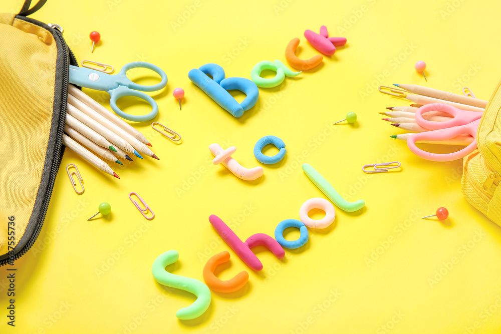 Text BACK TO SCHOOL and stationery on yellow background