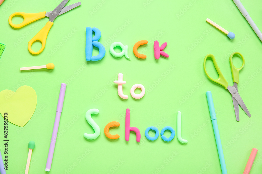 Text BACK TO SCHOOL and stationery on green background