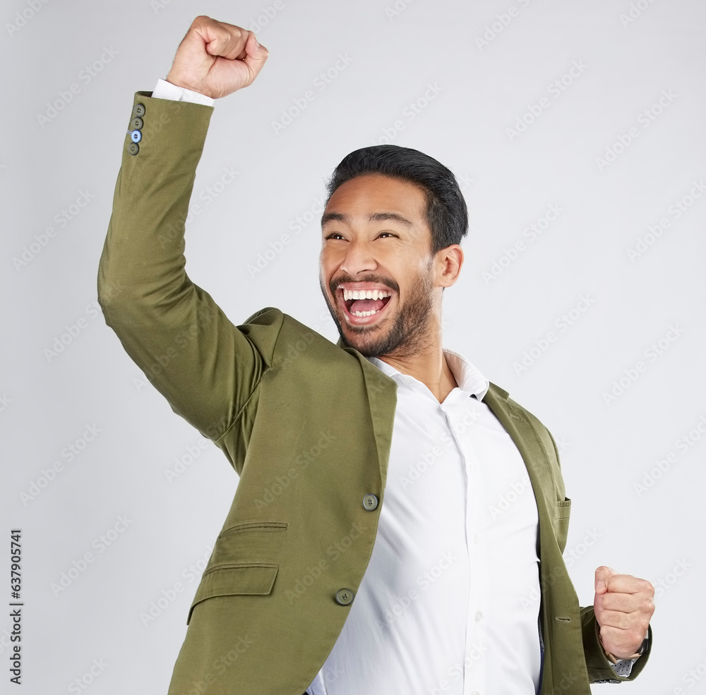 Happy asian man, fist pump and celebration in winning, success or promotion against a white studio b