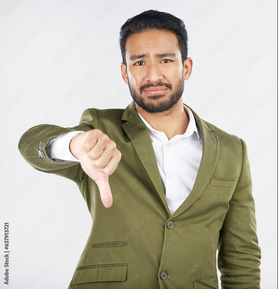 Sad, portrait and man with thumbs down in studio for rejection, no or bad review on grey background.