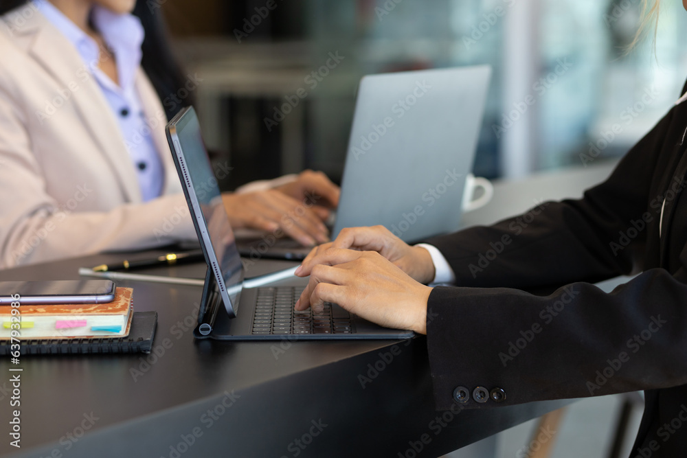 Businesswoman typing on laptop keyboard.