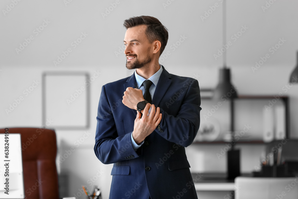 Handsome businessman with smartwatch working in office