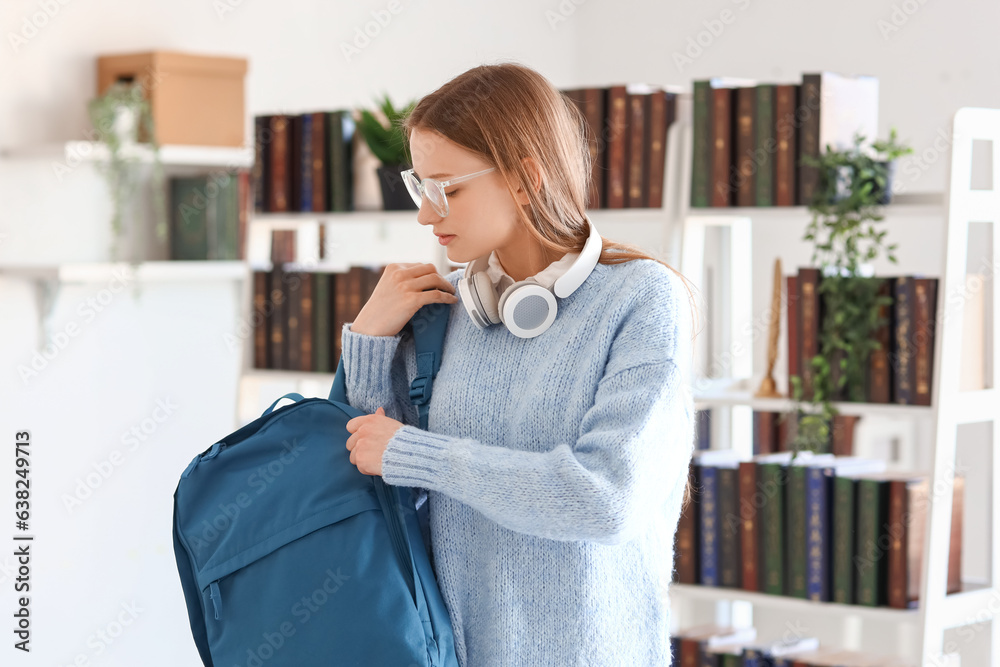 Female student with backpack in library