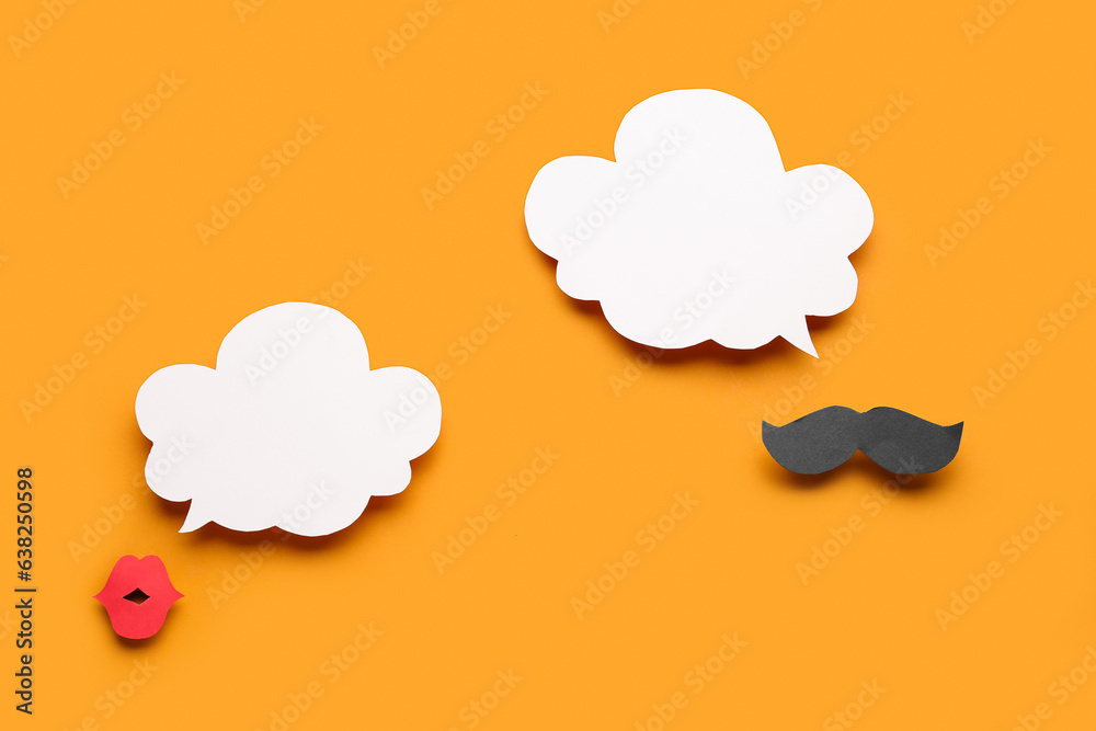 Paper mustache and lips with speech bubbles on orange background