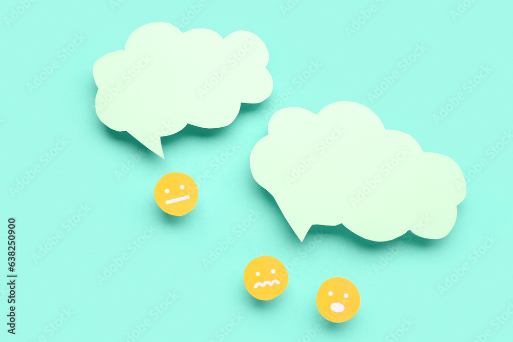 Arguing paper faces with blank speech bubbles on turquoise background