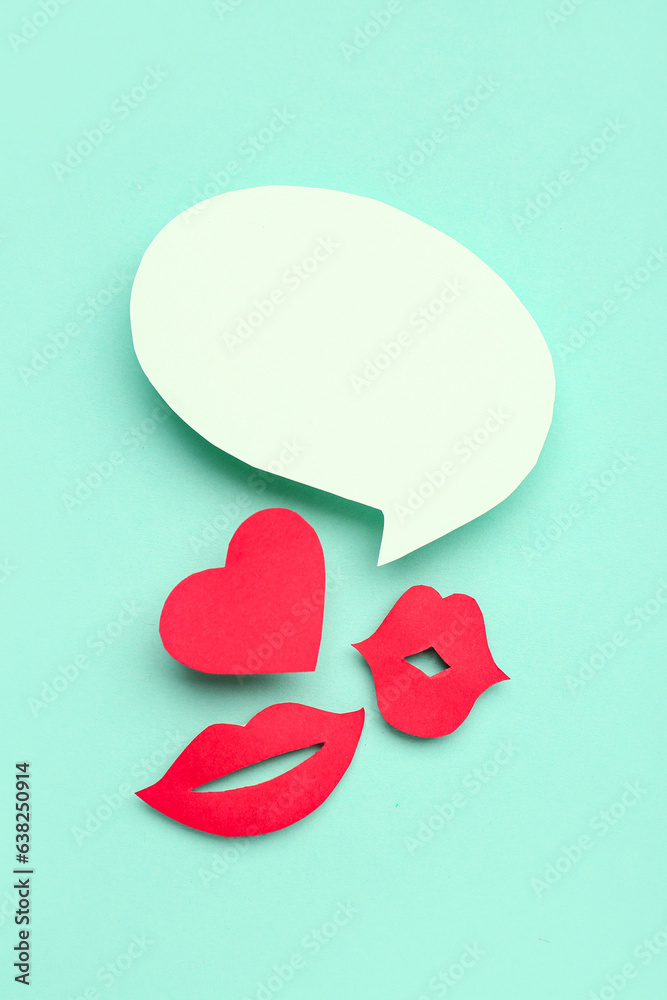 Paper lips and heart with blank speech bubble on turquoise background