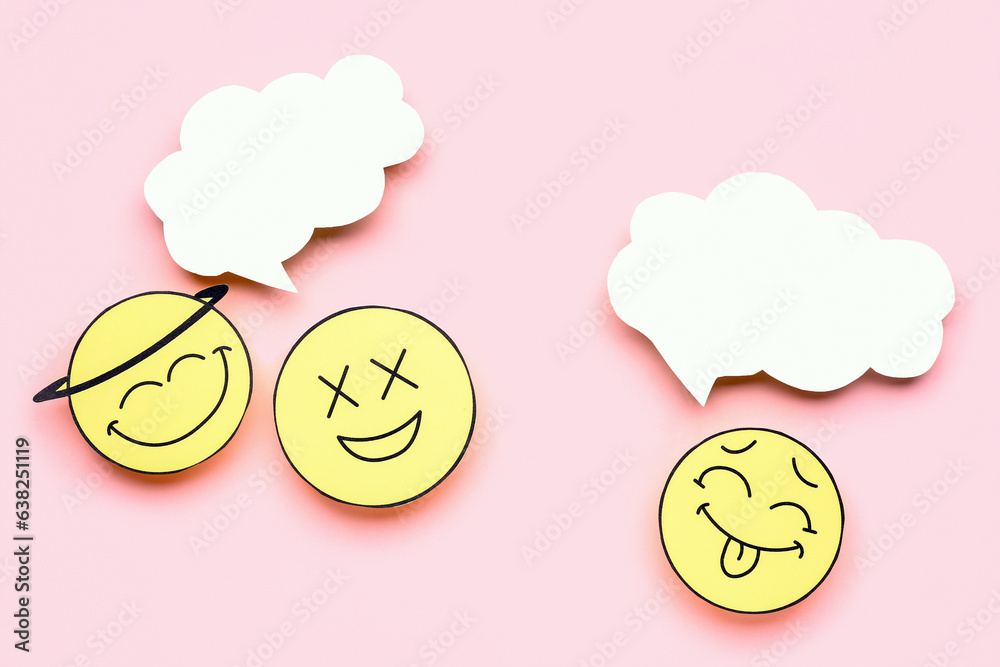 Paper faces with blank speech bubbles on pink background