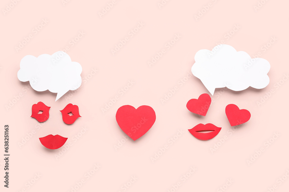 Paper lips and and hearts with blank speech bubbles on pink background