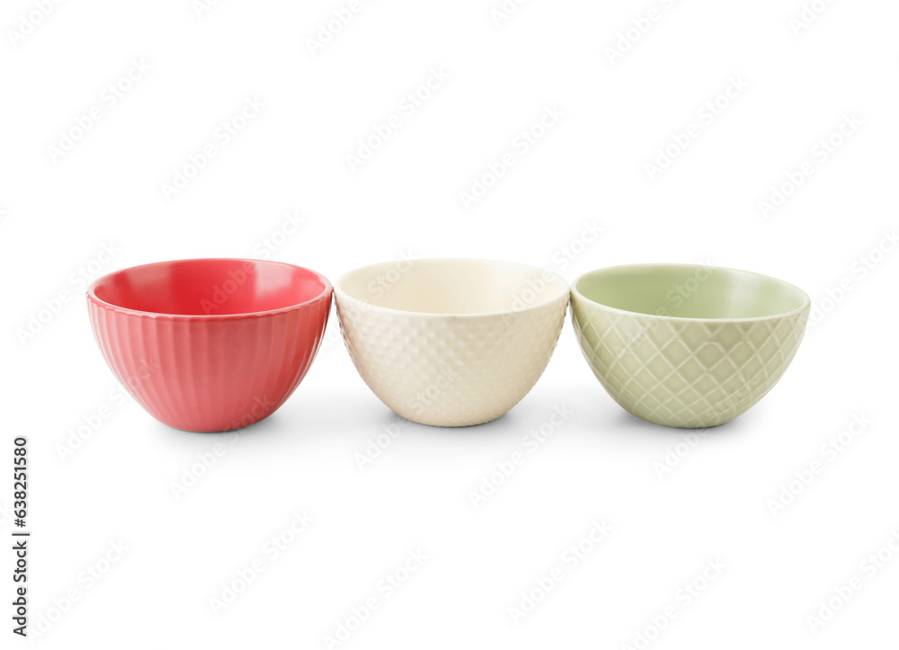 Set of color bowls on white background