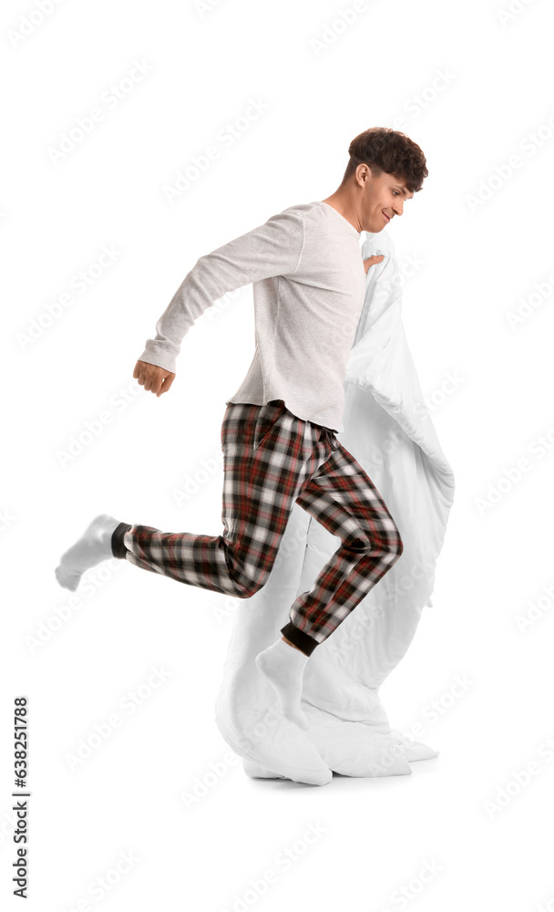 Handsome happy man with soft blanket jumping on white background