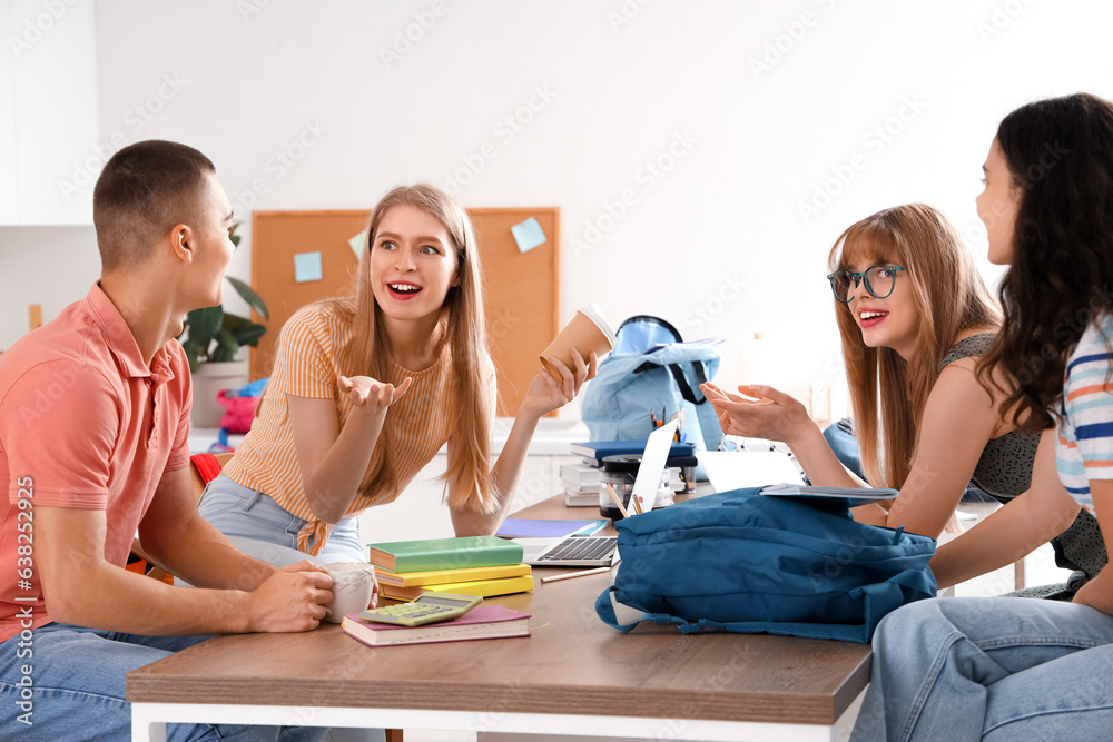 Group of students studying in kitchen