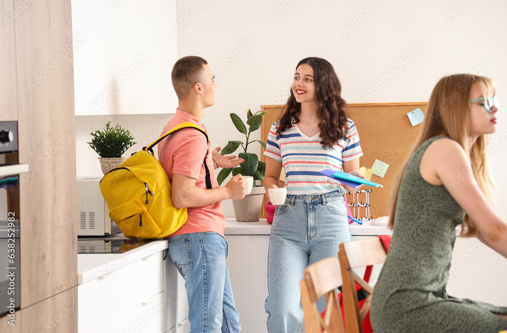 Students drinking coffee in kitchen