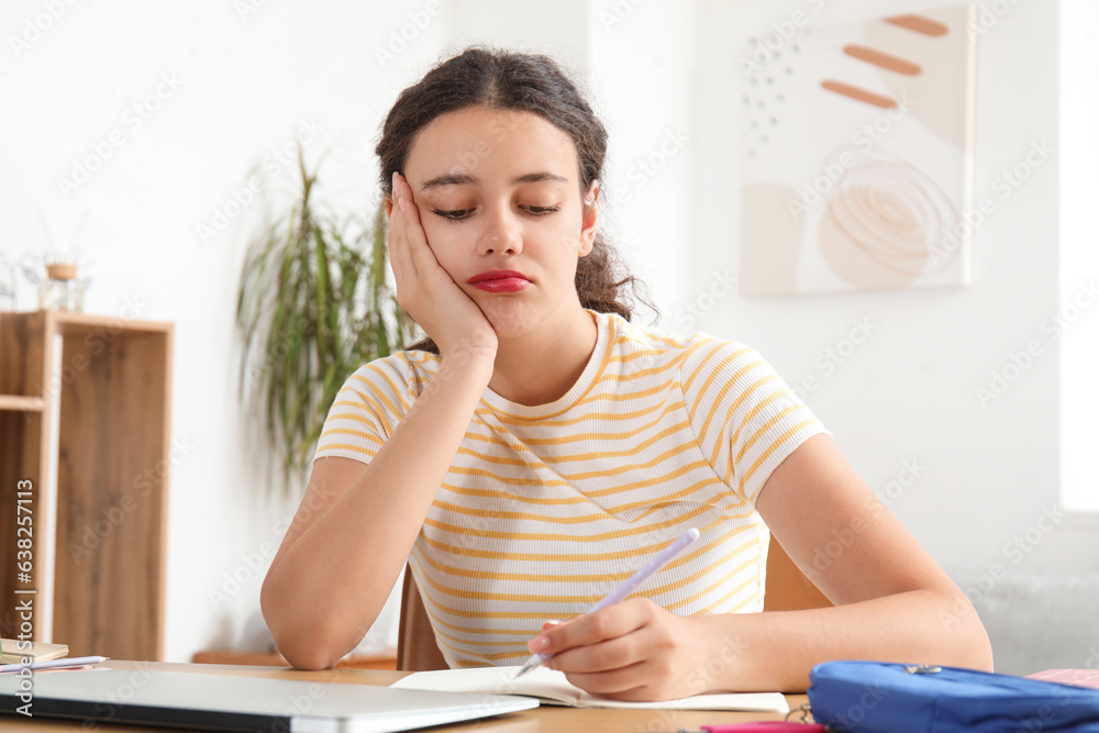 Female student doing lessons at home