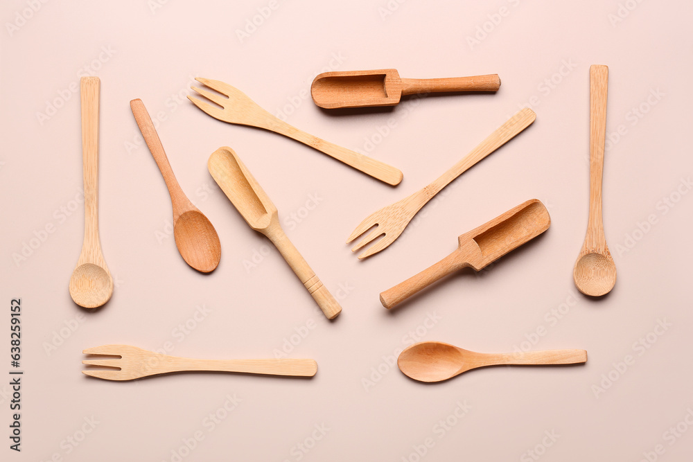 Wooden kitchen utensils on beige background