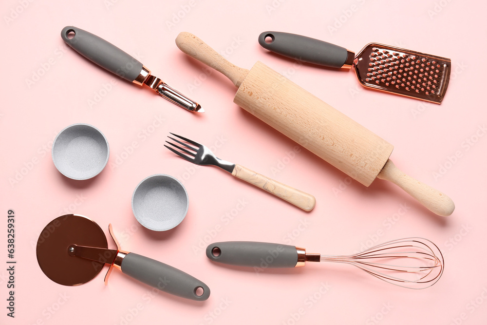 Set of kitchen utensils on pink background